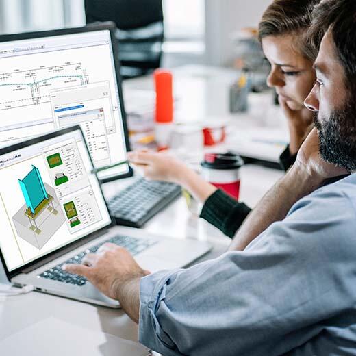 Man and lady working at computer on Tekla Portal Frame Designer