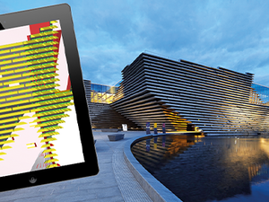 Tablet showing 3D model of V&A Dundee with museum in background at dusk