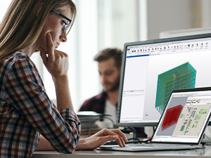 Girl sat at computer with Tekla Structural Designer and Rhino Grasshopper displayed