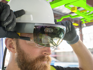 Man wearing headset with model in real world surroundings, mixed reality