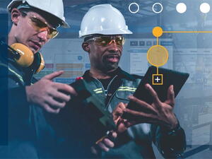 Two workers using Tekla PowerFab on a tablet